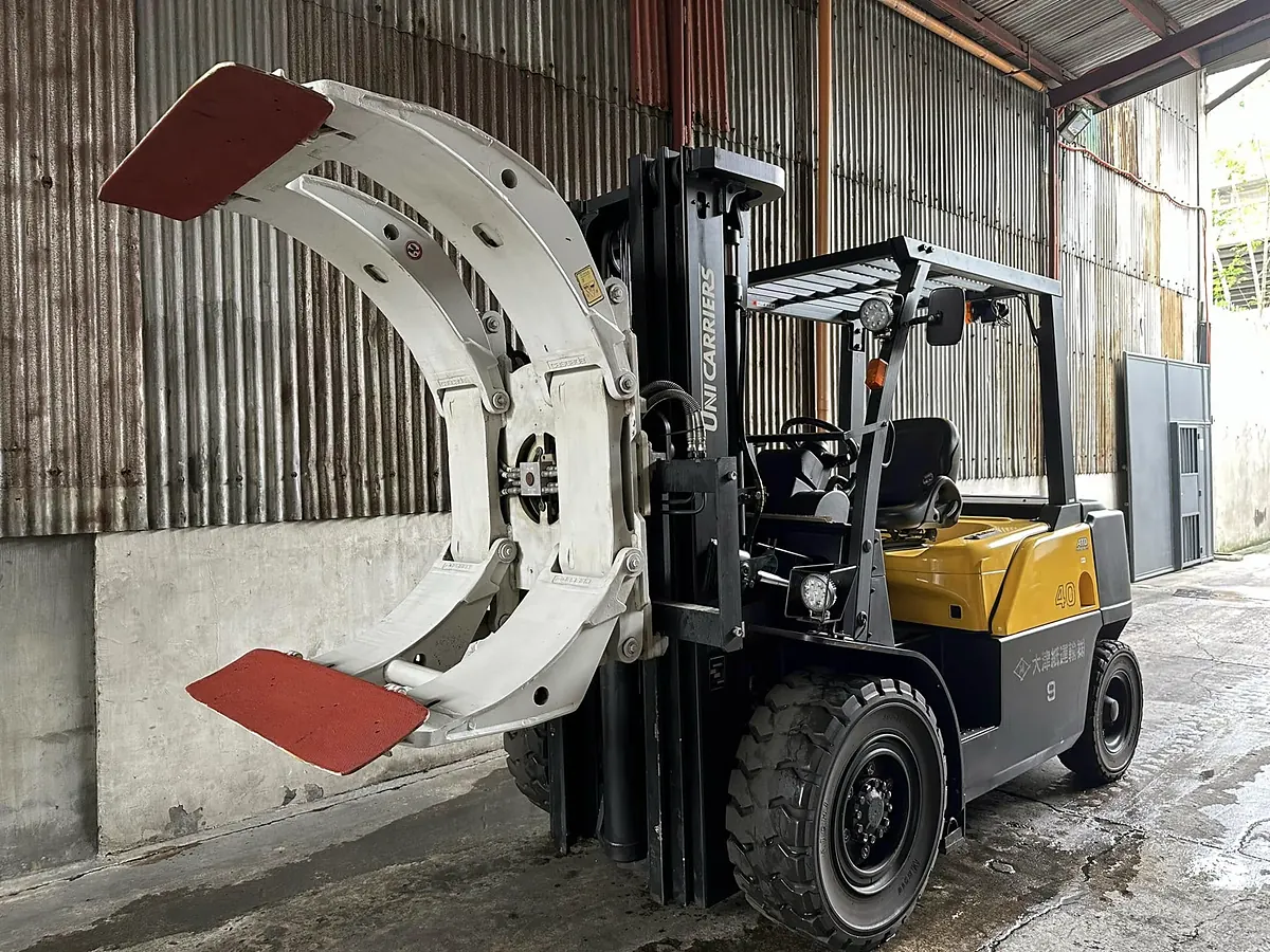UniCarriers 40 forklift fitted with a large paper roll clamp attachment